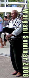 CLICK FOR FULL PHOTO OF QUADRANGLE ENTRANCE - Tony Tore, playing bagpipes welcoming WAIGANI SEMINAR 2008 participants at Univerristy of Papua New Guinea